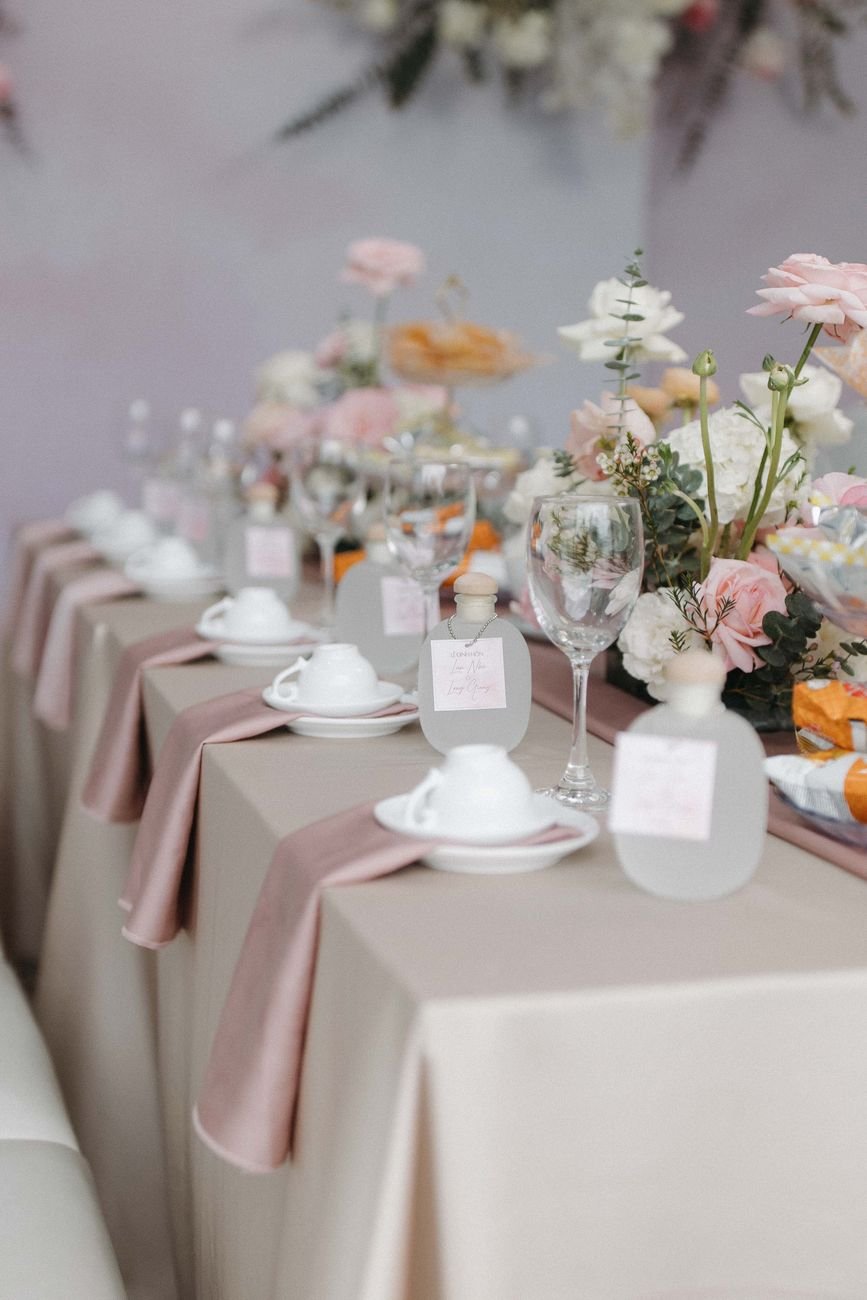 Beautifully decorated table with floral arrangements and elegant tableware in spring tones.